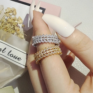 Macro shot of gold and silver willow leaf eternity rings with marquise-cut crystals