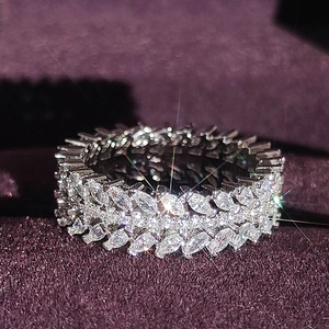Macro shot of silver ring with marquise-cut zircons in a full eternity willow leaf design
