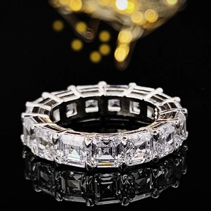 Elegant square-cut moissanite eternity ring in silver finish with black reflective background