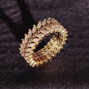 Macro detail of luxury golden willow leaf ring with marquise-cut crystal inlays