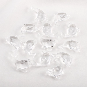 Macro shot of clear resin dolphin charms with high transparency for DIY jewelry making
