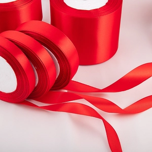 Glossy red polyester satin ribbons in rolls for luxury gift wrapping and wedding decor