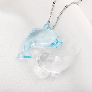 Blue and clear dolphin resin pendants on delicate silver necklaces for ocean jewelry