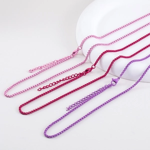 Close-up of box chain necklaces in pink and purple with adjustable lobster clasps