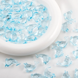 Macro detail of transparent blue dolphin resin beads for DIY jewelry and necklaces