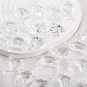 Macro shot of blue transparent resin dolphin pendant beads for DIY jewelry making