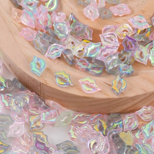 Macro shot of iridescent resin lip charms for DIY nail art and slime decorations