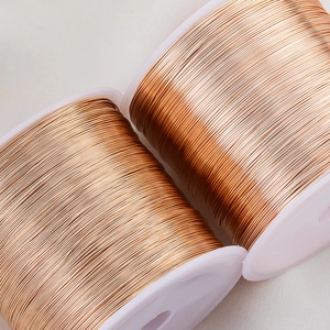 Macro detail of two rose gold copper wire spools for DIY jewelry making and wire wrapping
