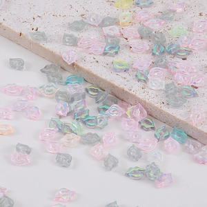 Macro detail of laser aurora lip-shaped resin nail art charms in assorted iridescent colors