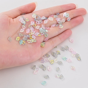 Laser holographic lip-shaped nail art sequins in various colors on hand palm