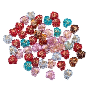 Macro view of maple leaf acrylic beads with gold veins for DIY jewelry making