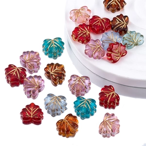 Macro shot of colorful acrylic maple leaf beads with gold veins for DIY jewelry making