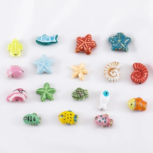 Macro view of colorful ocean life polymer clay beads including sea stars and turtles