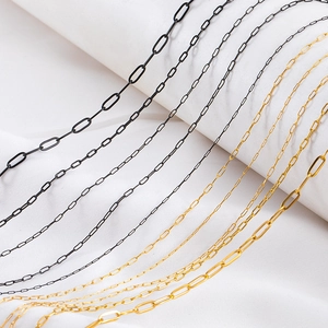 Macro shot of gold and black stainless steel paperclip chains for DIY jewelry making