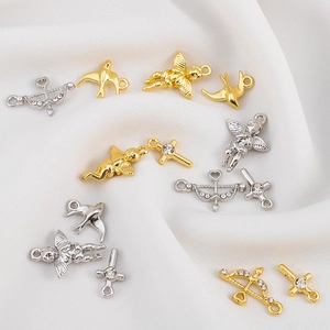 Detailed close-up of gold and silver Cupid and cross charms for DIY jewelry making
