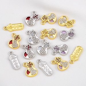 Detailed view of alloy Fu gourds and rectangular charms with rhinestones and enamel