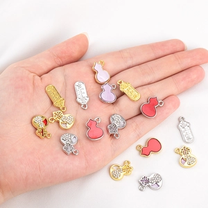 Detailed macro view of alloy gourd charms with crystals and enamel for DIY jewelry making
