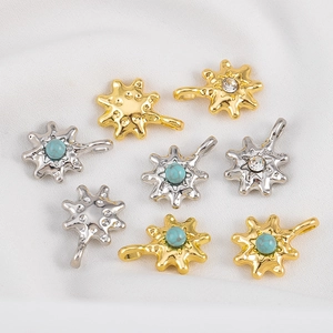 Detailed view of gold and silver sunburst charms with turquoise and zircon inlays