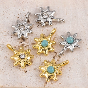Detailed shot of starburst pendants with turquoise and rhinestones for DIY jewelry