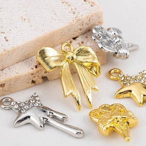 Pendentifs étoile et nœud avec strass pour bijoux DIY en finitions dorée et argentée