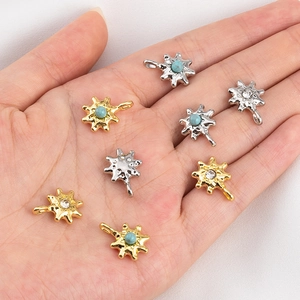 Eight starburst pendant charms in gold and silver finish with inlaid colorful stones