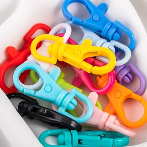 Close-up of colorful plastic lobster clasps in various shades for DIY craft projects