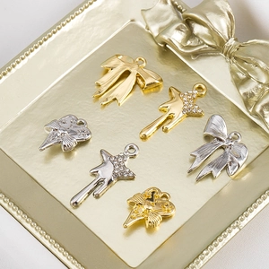 Détail de pendentifs bijoux DIY avec motifs étoile, cœur et nœud en finitions or et argent