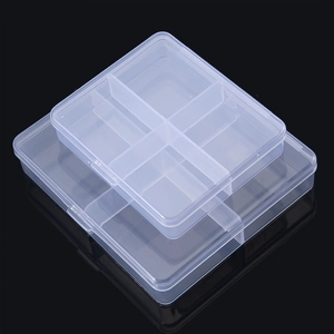 Macro view of two stacked transparent plastic organizer boxes with four compartments