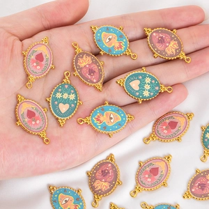 Detail of colorful enamel flame eye and heart charms in gold stainless steel for DIY jewelry