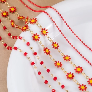 Detailed view of red sunflower and square bead gold chains for DIY jewelry making