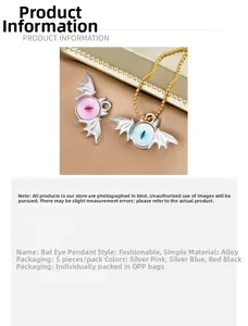Close-up of alloy bat evil eye pendants in silver with pink and blue pupils detail