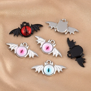 Detailed macro view of dark gothic bat eye alloy pendants in red, blue, and pink colors