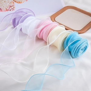 Detail of colorful organza fish tail ribbons with delicate wavy edges for gift wrapping