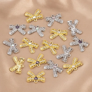 Detailed close-up of bow-knot pendants with rhinestones and heart-shaped colorful stones