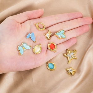 Detailed close-up of mixed alloy charms with gold plating and rhinestones for DIY jewelry