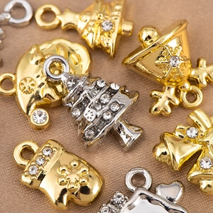 Macro shot of Christmas alloy charms with sparkling rhinestones and gold-silver plating