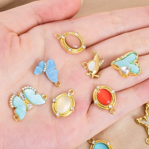 Macro shot of colorful alloy charms with rhinestones and gold plating for DIY jewelry