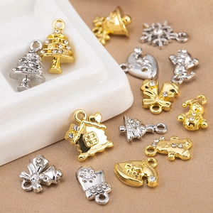 Macro detail of Christmas alloy charms including snowflakes and bells with rhinestones