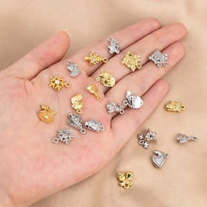 Close-up of Christmas alloy charms including Santa and snowman on a satin background