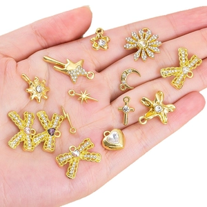 Selection of gold alloy pendants with zircon butterfly and heart motifs for DIY jewelry