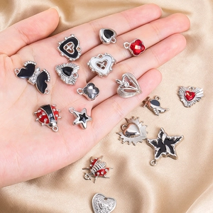 Detail of alloy charm set with black enamel butterflies and hearts for DIY jewelry making