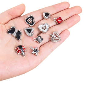 DIY black alloy charms set featuring heart butterfly and clover shapes with enamel detail