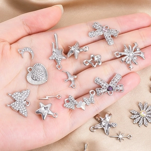 Detailed macro view of assorted silver alloy pendants with cubic zirconia for DIY jewelry making