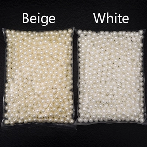 Comparison of beige and white ABS imitation pearls with smooth finish for DIY jewelry