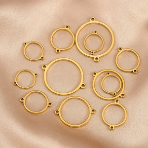 Golden stainless steel circle connector charms for jewelry making on champagne silk fabric