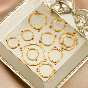 Polished gold circle pendant connectors for DIY jewelry displayed on luxury tray