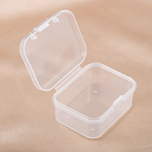 Detailed macro view of open transparent PP plastic storage box on silk fabric surface