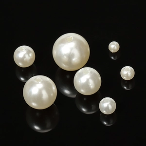 Detail of cream white faux pearl beads with hole for DIY jewelry making and crafts