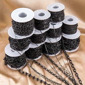 Macro view of gunmetal DIY jewelry chains on spools for handmade accessories