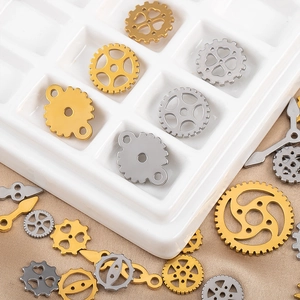 Macro detail of mixed gold and silver steampunk mechanical gears and clock hand charms